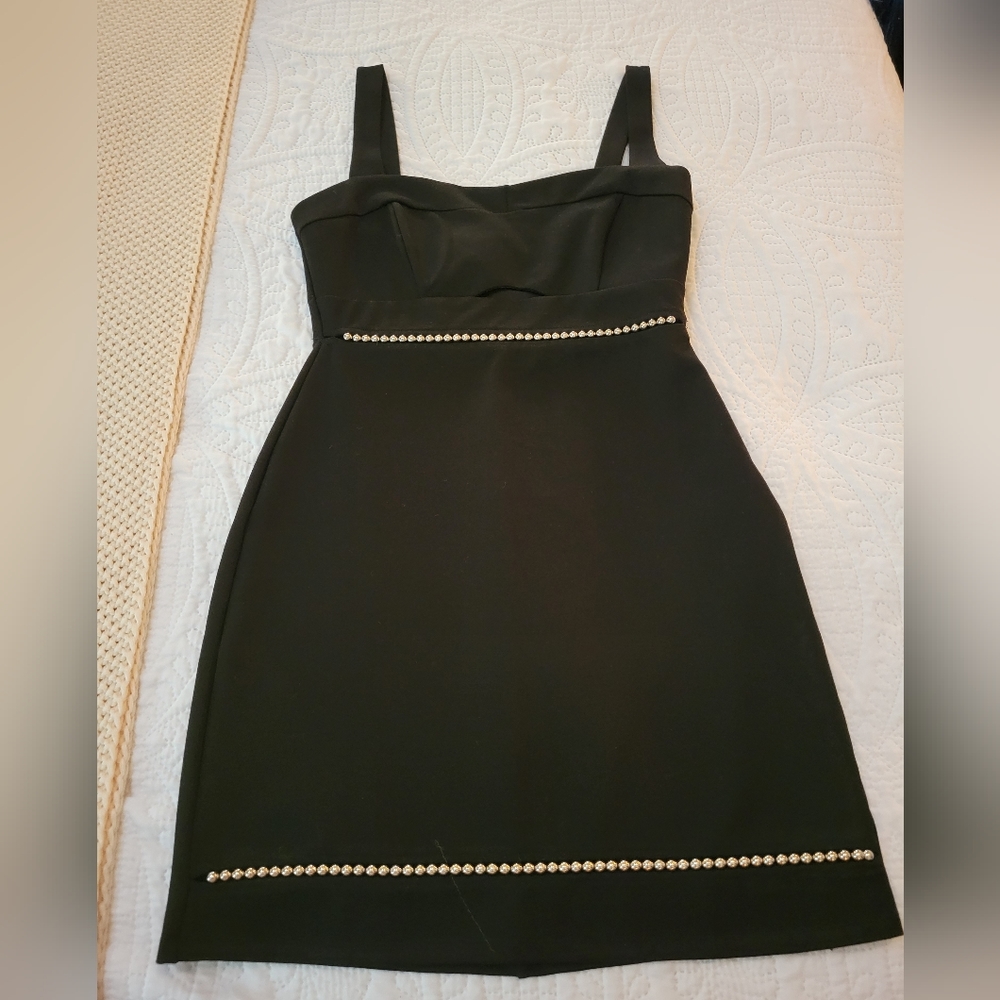 Astr little black dress with silver stud details in front.
